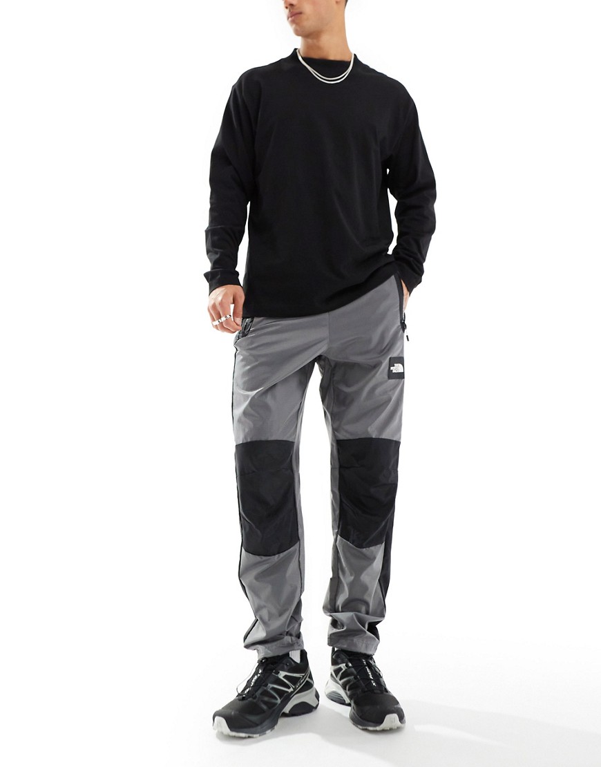 The North Face NSE wind sheel trousers in grey and black