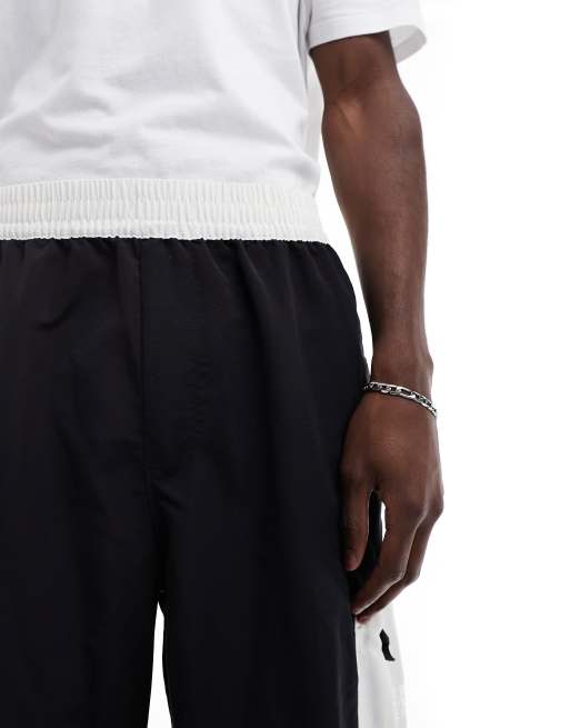 The North Face Nylon woven loose fit joggers in black and white