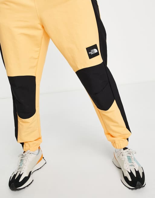 The North Face Phlego Track joggers in yellow ASOS