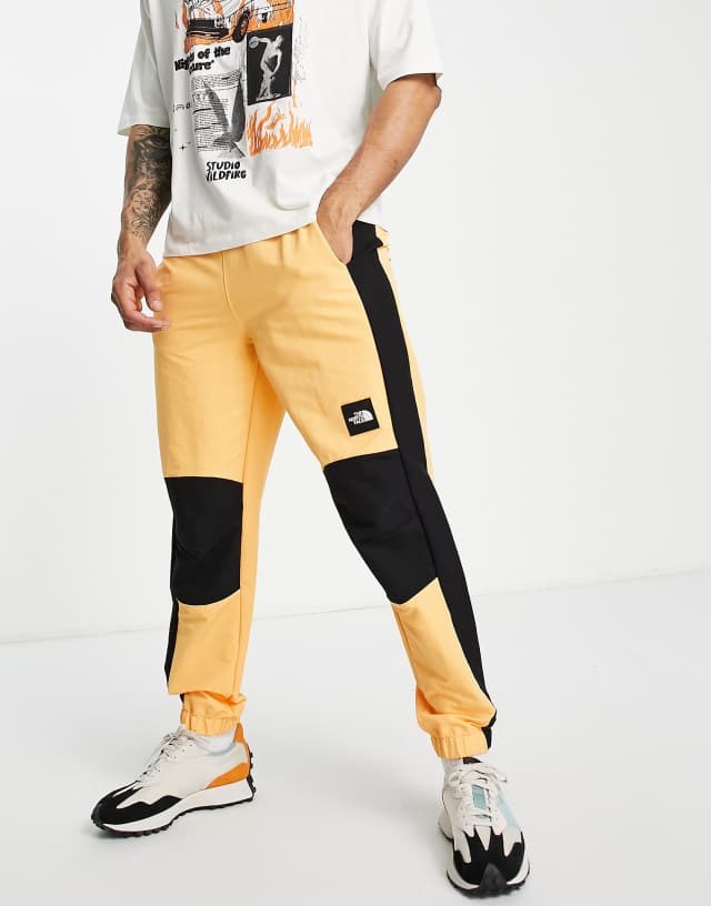 The North Face Phlego track sweatpants in orange