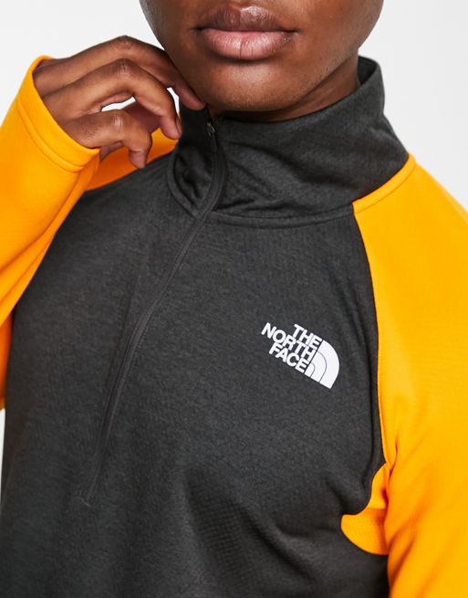 The North Face Running 1/4 Zip FlashDry long sleeve top in orange and black