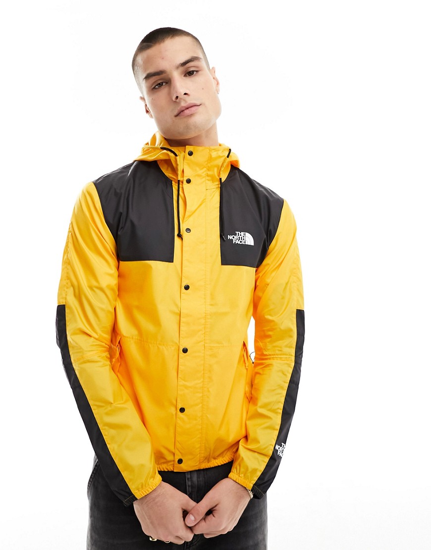 The North Face Seasonal Mountain packable jacket in yellow and black