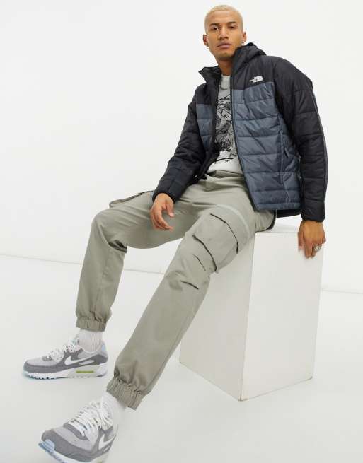 The North Face Synthetic puffer jacket in khaki and black Exclusive at ASOS