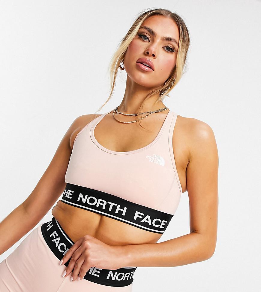 The North Face Tech sports bra in light pink Exclusive at ASOS