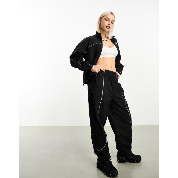 The North Face Tek woven track pants with reflective piping in