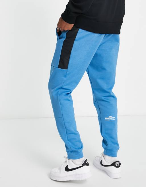 The North Face Training Mountain Athletic joggers in blue ASOS