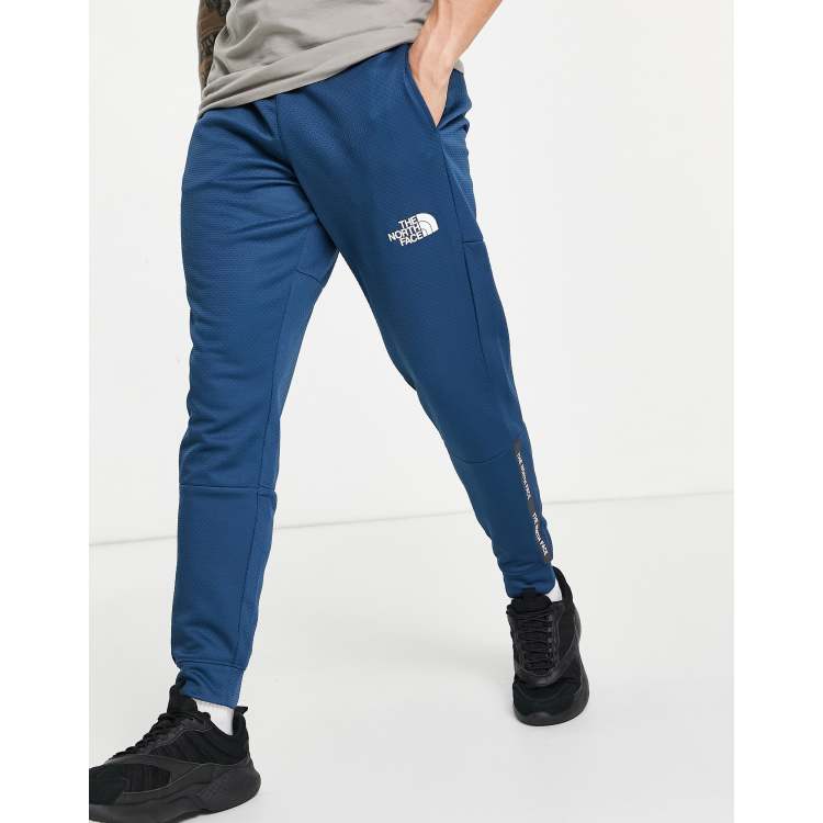 The North Face Training Mountain Athletic joggers in blue ASOS