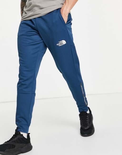 The North Face Training Mountain Athletic trackies in blue 