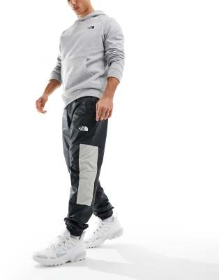 The North Face Training Mountain Athletics wind track joggers in black - ASOS Price Checker