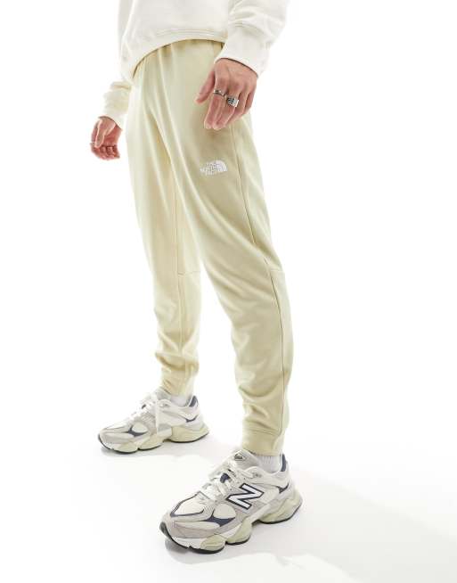 The North Face - Training Reaxion - Joggers beige mélange con logo