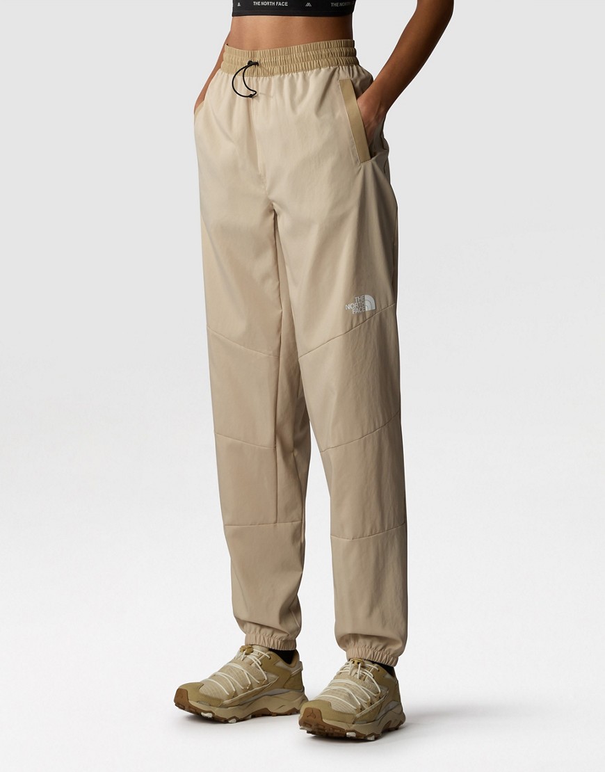 The North Face Training Mountain Athletics wind track joggers in sand-Neutral