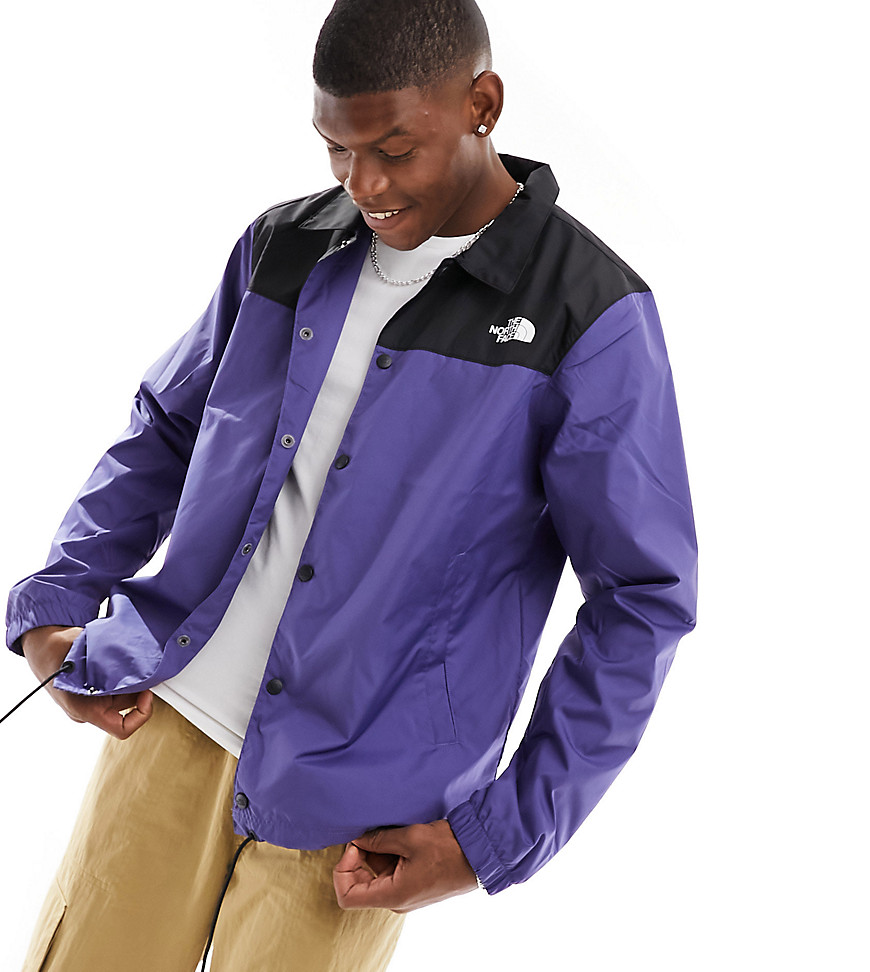 The North Face water-repellent coach jacket in blue and black Exclusive at ASOS
