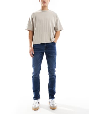 slim fit jeans in mid wash blue