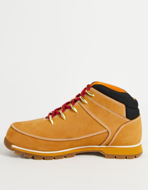 Tan hiking boots store with red laces