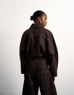 Model wearing Tolu Coker x Topshop barrel denim jacket circular design in brown rinse