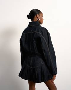 Model wearing Tolu Coker x Topshop barrel denim jacket circular design in indigo blue
