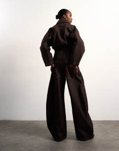 Model wearing Tolu Coker x Topshop barrel high rise jean circular design in brown rinse