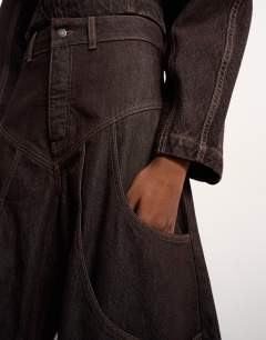 Model wearing Tolu Coker x Topshop barrel high rise jean circular design in brown rinse