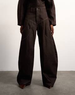 Model wearing Tolu Coker x Topshop barrel high rise jean circular design in brown rinse