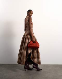 Model wearing Tolu Coker x Topshop check open back midi dress in brown check