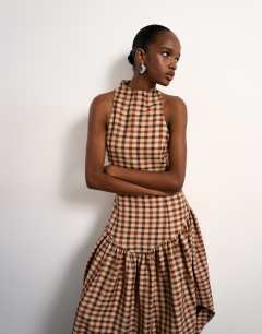 Model wearing Tolu Coker x Topshop check open back midi dress in brown check