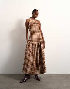 Model wearing Tolu Coker x Topshop check open back midi dress in brown check