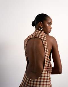 Model wearing Tolu Coker x Topshop check open back midi dress in brown check