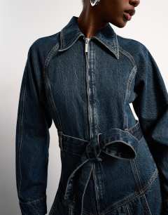 Model wearing Tolu Coker x Topshop denim barrel leg jumpsuit circular design in deep blue