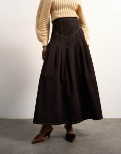Model wearing Tolu Coker x Topshop denim maxi pleated skirt circular design in brown rinse