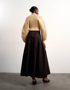 Model wearing Tolu Coker x Topshop denim maxi pleated skirt circular design in brown rinse