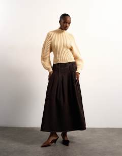 Model wearing Tolu Coker x Topshop denim maxi pleated skirt circular design in brown rinse