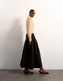 Model wearing Tolu Coker x Topshop knitted ovoid sleeve jumper in beige