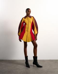 Model wearing Tolu Coker x Topshop knitted ovoid sleeve structured dress in multi