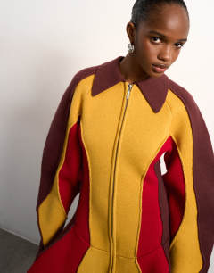 Model wearing Tolu Coker x Topshop knitted ovoid sleeve structured dress in multi