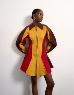 Model wearing Tolu Coker x Topshop knitted ovoid sleeve structured dress in multi