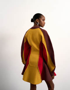 Model wearing Tolu Coker x Topshop knitted ovoid sleeve structured dress in multi
