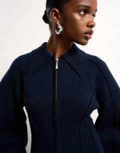 Model wearing Tolu Coker x Topshop knitted ovoid sleeve structured dress in navy