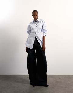 Model wearing Tolu Coker x Topshop stripe long sleeve shirt in blue stripe