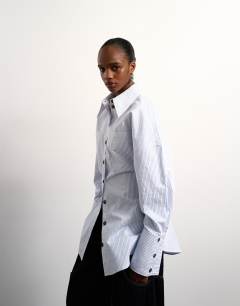 Model wearing Tolu Coker x Topshop stripe long sleeve shirt in blue stripe