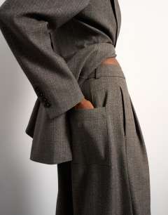 Model wearing Tolu Coker x Topshop tailored longline short in taupe