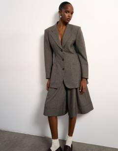 Model wearing Tolu Coker x Topshop tailored longline short in taupe