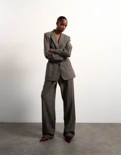 Model wearing Tolu Coker x Topshop tailored trouser in taupe