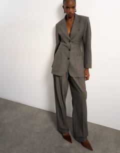 Model wearing Tolu Coker x Topshop tailored trouser in taupe