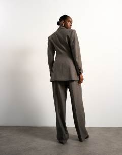 Model wearing Tolu Coker x Topshop tailored trouser in taupe