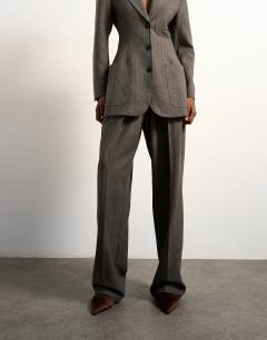 Model wearing Tolu Coker x Topshop tailored trouser in taupe