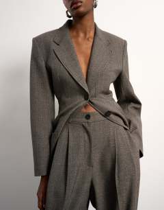 Model wearing Tolu Coker x Topshop tailored trouser in taupe