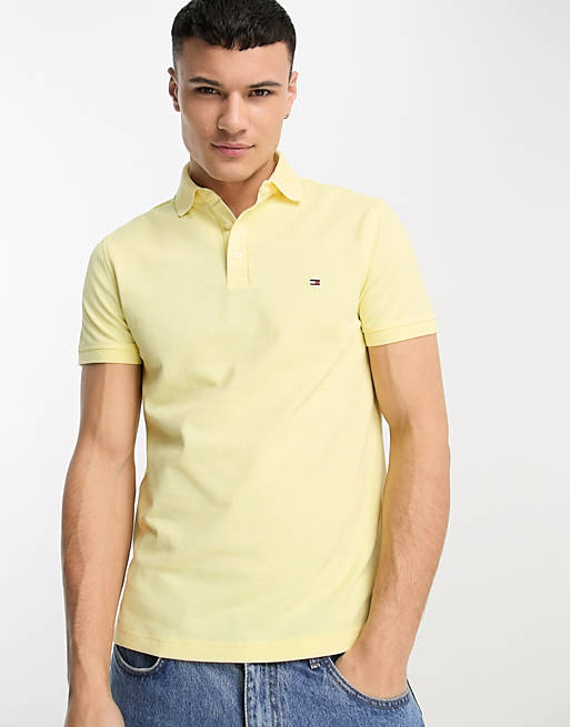 Tommy Hilfiger 1985 flag logo slim fit polo shirt in yellow | ASOS