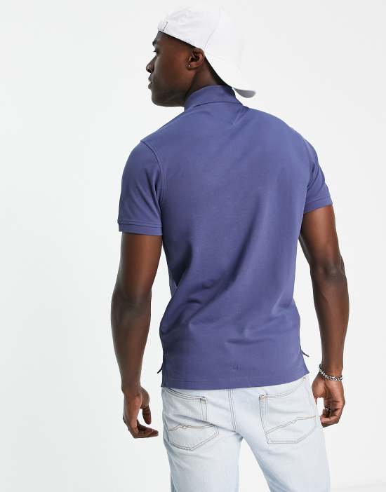 https://images.asos-media.com/products/tommy-hilfiger-1985-icon-logo-slim-fit-pique-polo-shirt-in-dark-blue/202423450-4?$n_550w$&wid=550&fit=constrain