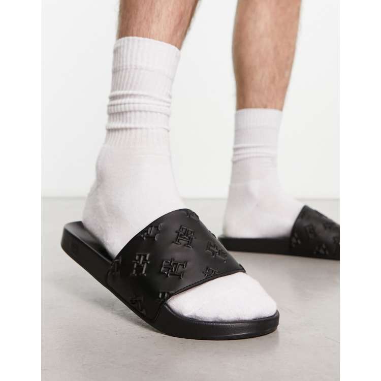 transfusion Uden tvivl hydrogen Tommy Hilfiger embossed monogram slides in black | ASOS