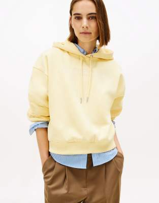 Tommy Hilfiger - Flex - Locker geschnittener Fleece-Kapuzenpullover in Hellgelb mit Logo-Stickerei